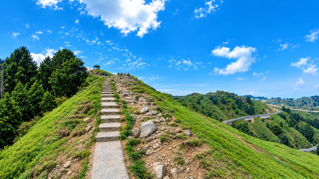 Stone steps up the grassy Dainkund Peak ridge with a hilltop gazebo near Dalhousie