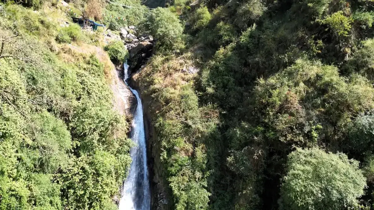 Bhagsu waterfall dropping through a green gorge near McLeod Ganj