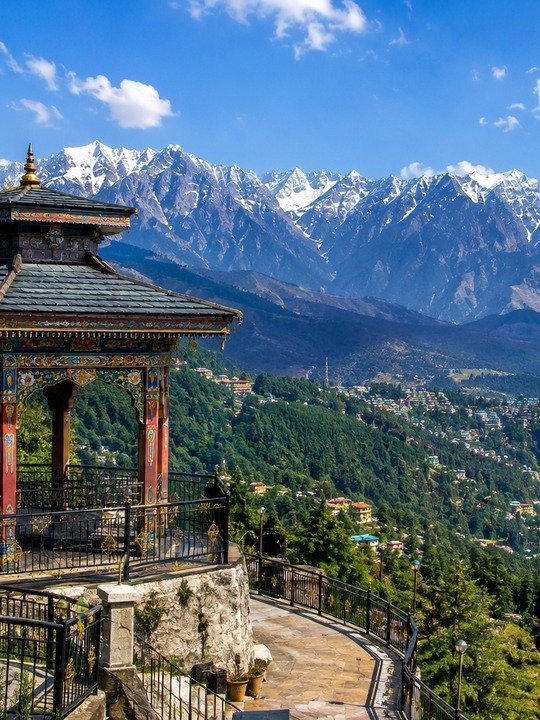 Tibetan-style viewpoint pavilion facing the snowy Dhauladhar range at Dharamshala