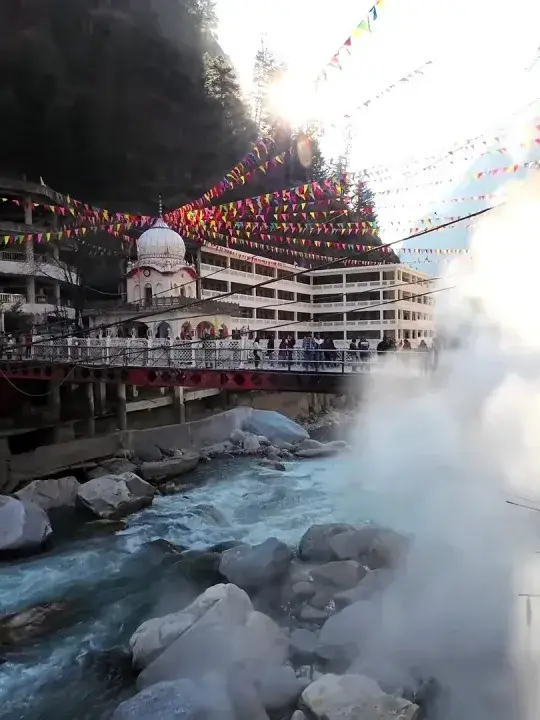Hot spring steam rising beside Gurudwara Manikaran Sahib on the Parvati River
