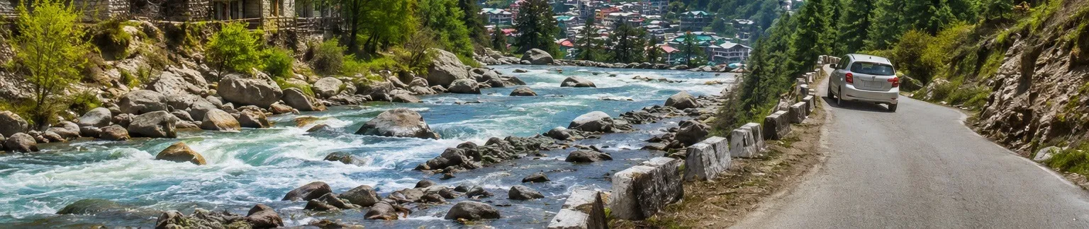 Beas River flowing past hotels and a riverside road in Manali