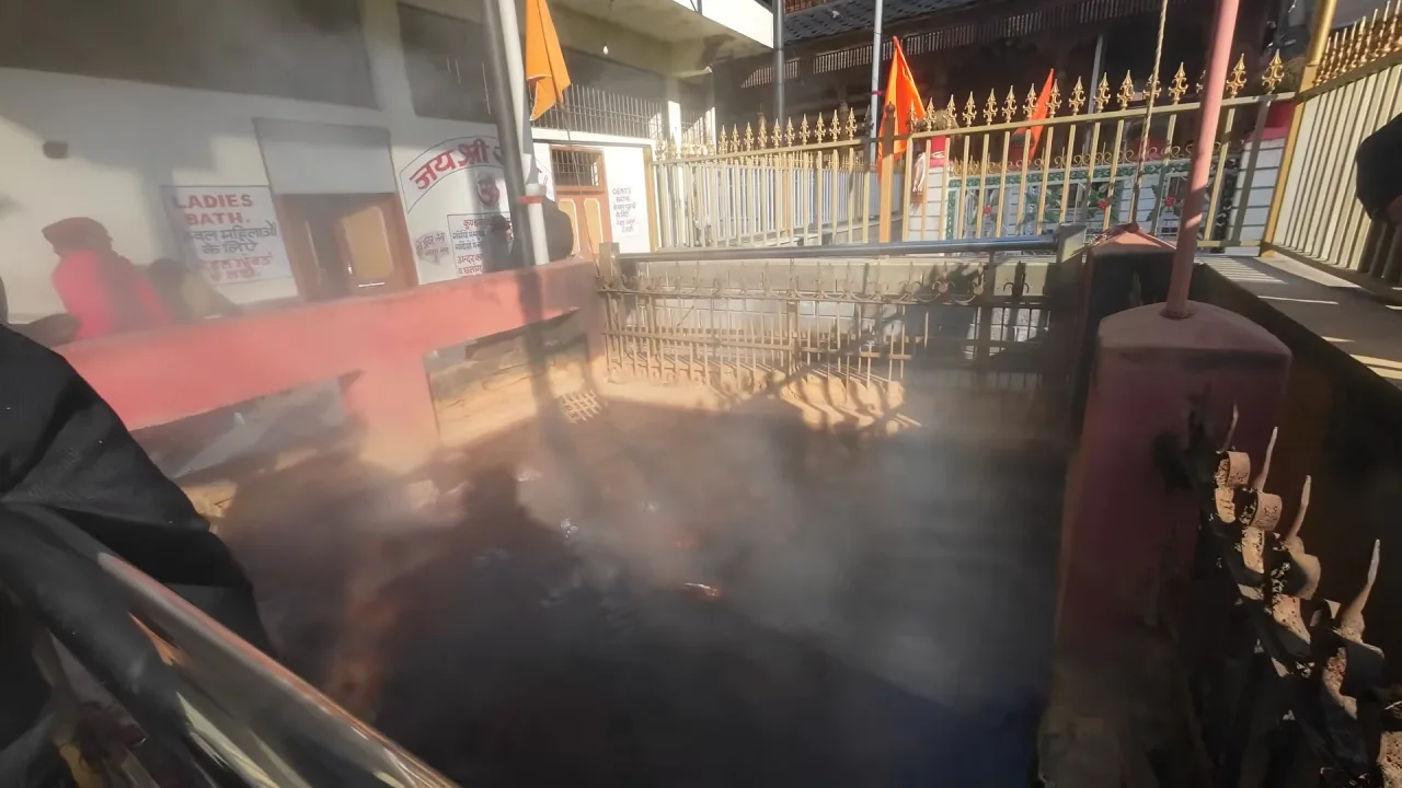 Steam rising from a hot spring pool at Manikaran
