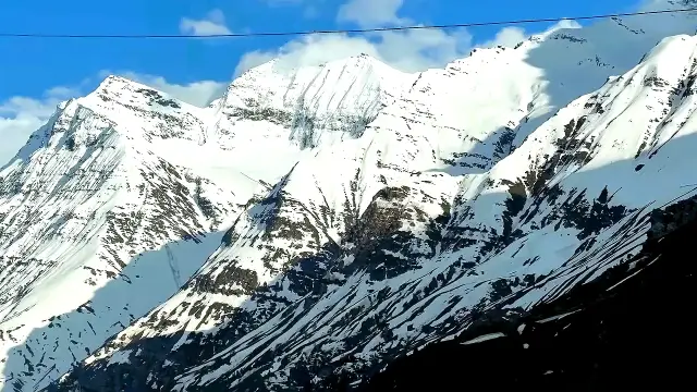 Snowy Himalayan peaks under a blue sky