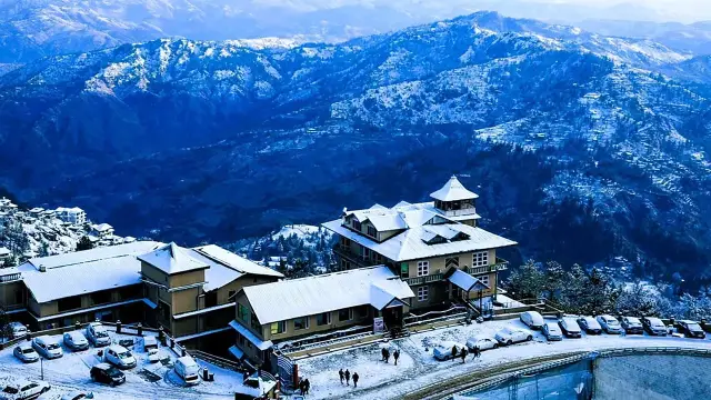 Snow-covered hill hotel overlooking a mountain valley in winter