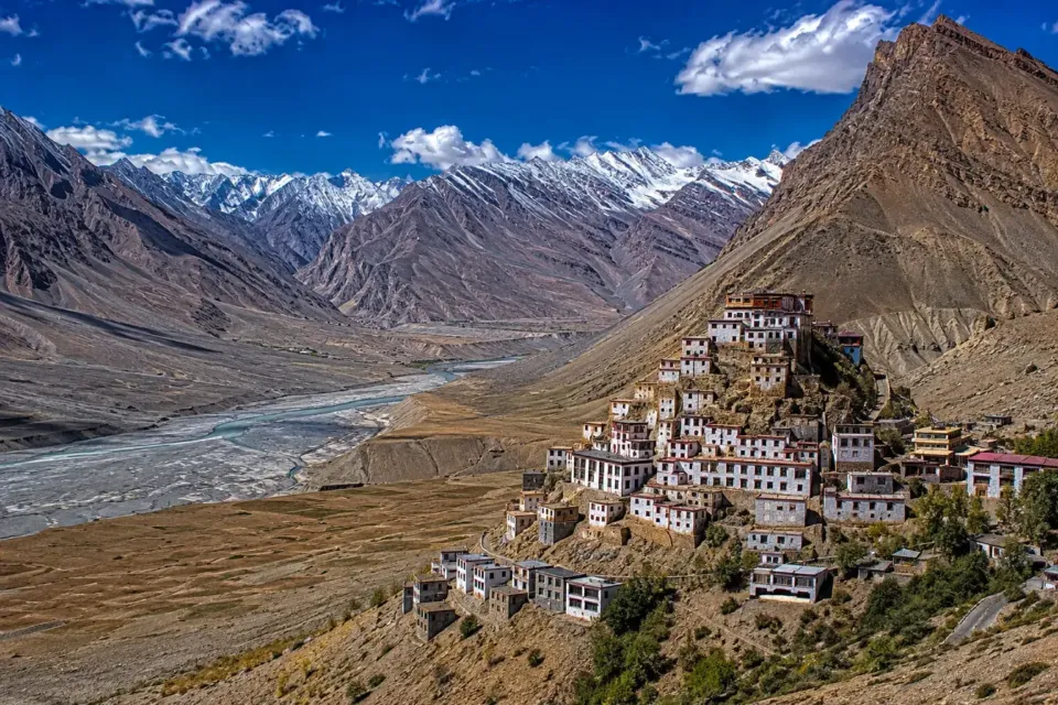 Key Monastery on a hillside above the Spiti river valley with snowy peaks behind